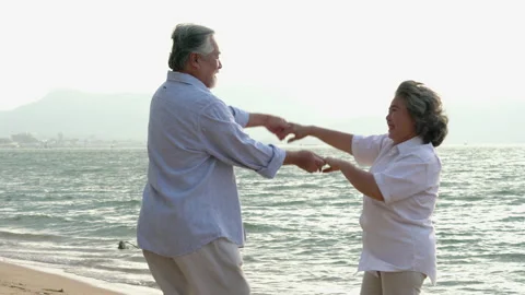 Senior couple dancing on the beach. Stock Footage 177971726