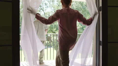 A senior couple dancing outside on their patio on a sunny day Stock Footage 151812926