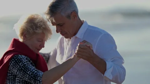 Senior couple dancing tango on beach Stock Footage 309562469