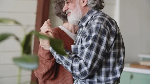 Senior couple dancing together in kitchen smiling. retreat, retirement and Stock Footage 243920018