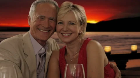 Senior couple at dinner in sunset looking at camera Stock Footage 43678224