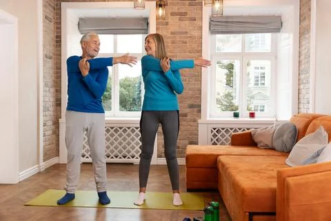 Senior Couple Doing Stretching Exercise Stock Photos