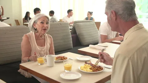 Senior Couple Enjoying Breakfast In Hotel Restaurant Stock Footage