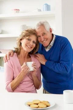 Senior Couple Enjoying Hot Drink In Kitchen Stock Photos