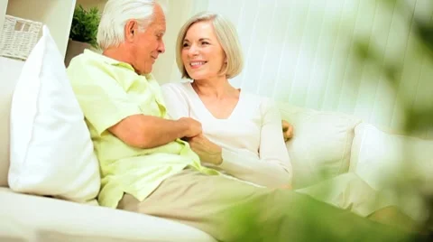 Senior Couple Enjoying Retirement Relaxing at Home Stock Footage