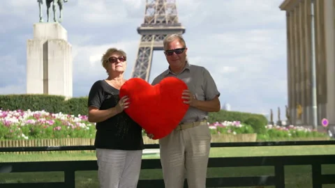 Senior couple in front of Eiffel tower in 4k slow motion 60fps Stock Footage 98524525