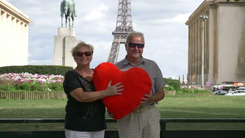 Senior couple in front of Eiffel tower in 4k slow motion 60fps Stock Footage 98525858