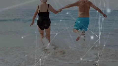 Senior couple holding hands, reaching waves, running, animated nodes tracing Stock Footage 333833786