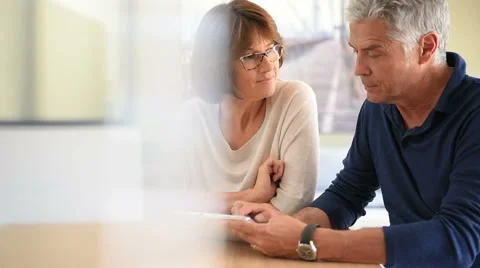 Senior couple at home using digital tablet Stock Footage 63898334