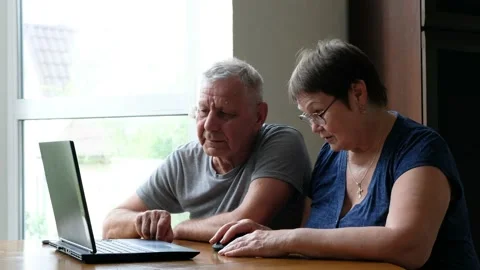 Senior couple at home using laptop. Retired family working on computer learning Stock Footage 133338540