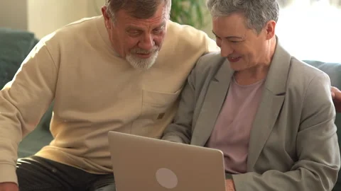 Senior couple at home using laptop. Retired family working on computer learning Stock Footage