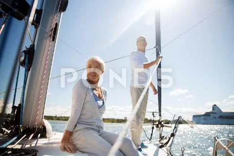 Senior couple hugging on sail boat or yacht in sea Stock Photos