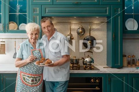 Senior couple in the kitchen. Cooking, life after retirement Stock Photos