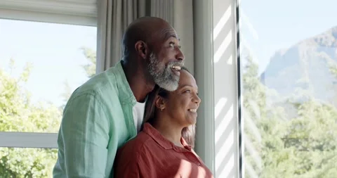 Senior couple leaning at window man spotting hill pointing together and admiring Stock Footage 340393288