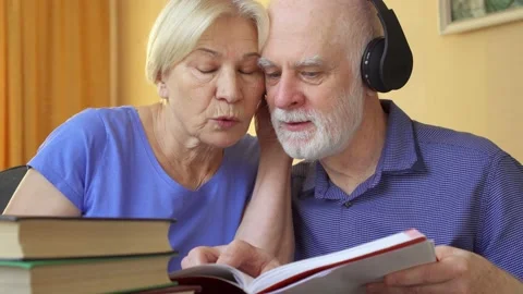 Senior couple learn foreign language with audio course. Man in headphones Video stock 139959517