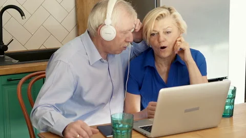 Senior couple learning a new language with laptop and having fun Stock Footage 126534280
