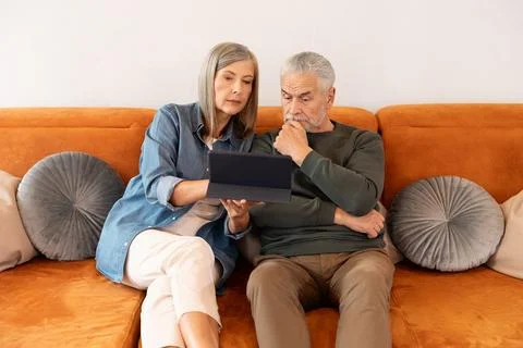 Senior Couple Learning To Use Digital Tablet . Stock Photos