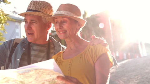 Senior couple looking at the map and pointing Stock Footage
