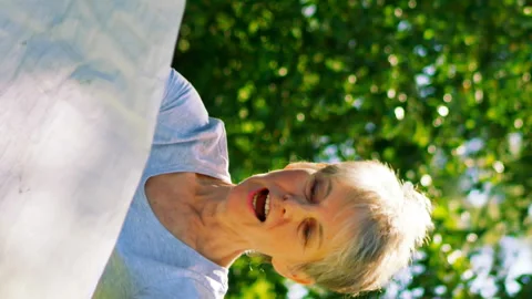 Senior couple looking at map in garden Stock Footage 300747224