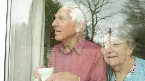 Senior couple looking out of a window Video stock 88444855