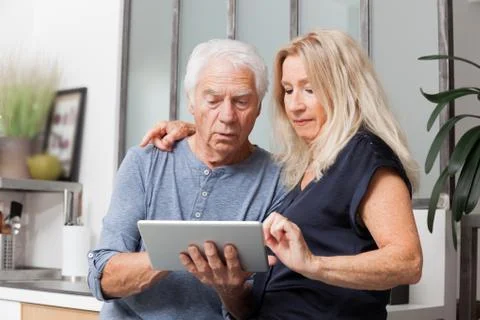 Senior couple looking at a tablet computer Foto stock
