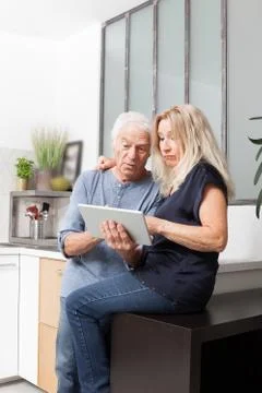 Senior couple looking at a tablet computer Stock Photos