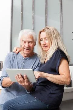 Senior couple looking at a tablet computer Foto stock