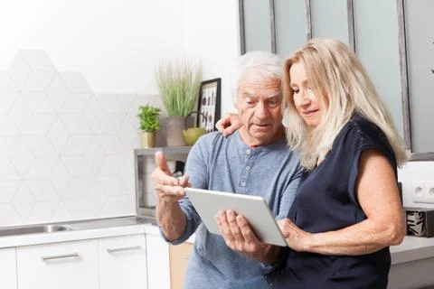 Senior couple looking at a tablet computer Stock Photos