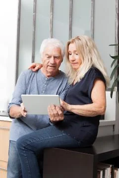 Senior couple looking at a tablet computer Stock Photos