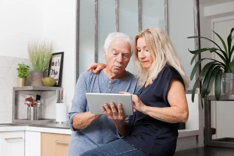 Senior couple looking at a tablet computer Stock Photos