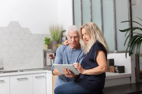 Senior couple looking at a tablet computer Stock Photos