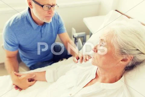 Senior couple meeting at hospital ward Stock Photos