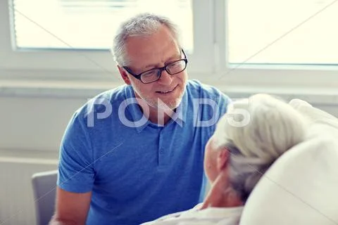 Senior couple meeting at hospital ward Stock Photos