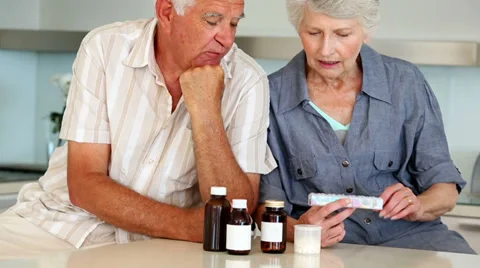 Senior couple organizing their medicine for the week Stock Footage