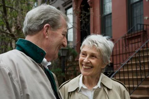 A senior couple outside of a brownstone Stock Photos