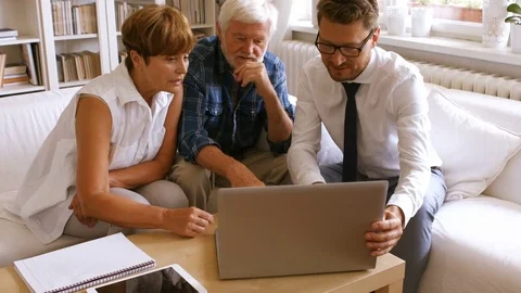 Senior couple planning their investments with financial advisor on laptop Stock Footage