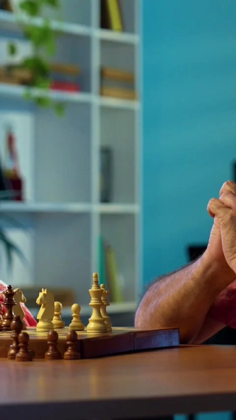 Senior couple playing chess board game at home for fun, bonding Stock Footage 343109602