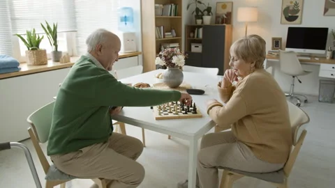 Senior Couple Playing Chess for Brain Health in Retirement Home Stock Footage 337613350
