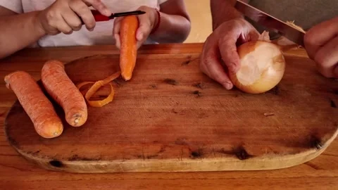 Senior couple preparing fresh vegetables for healthy meal together Stock Footage 328364078