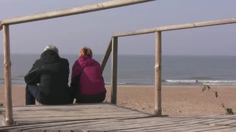 A senior couple relaxing on the seaside Stock Footage