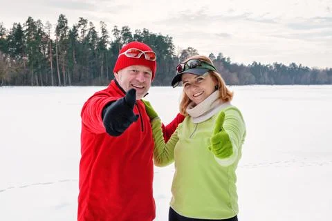 Senior couple resting while walking and showing thumb up Stock Photos