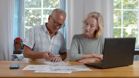 Senior couple scan qr-code to pay bill online at home Stock Photos