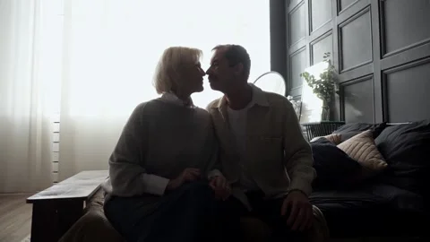 Senior couple sharing intimate moments in bedroom Stock Footage 303876868