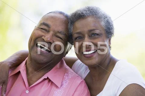 Senior couple sitting outdoors Stock Photos