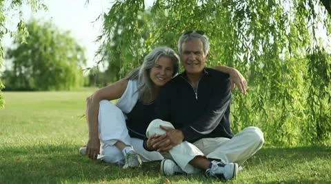Senior couple sitting under a tree; Full HD Photo JPEG Video stock 10610267