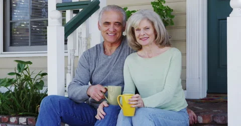 Senior couple smiling on porch Stock Footage