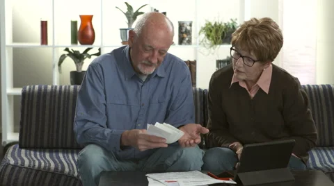 A senior couple stressed over paying bills Stock Footage