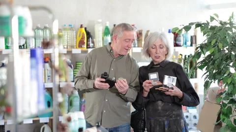 Senior couple, studies label and choose perfume and eye shadow pallet Stock-Footage 307065859