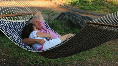 SENIOR COUPLE SWING IN HAMMOCK Stock Footage 28837063