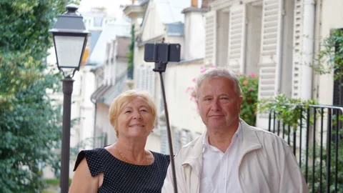Senior couple taking selfie on Paris street in 4k slow motion 60fps Stock Footage 94882703